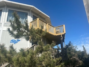A building with a wooden deck and a sign that reads 'AIA Resort Village.'