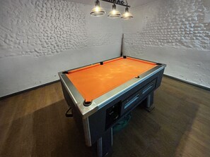 A pool table with a light fixture above it. - 4 bedroom accommodation in Swafield, near North Walsham (Swafield, near North Walsham)