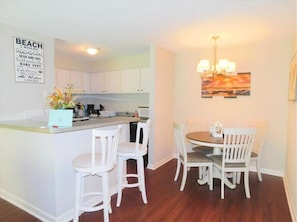 Modern kitchen and dining area with a central island and dining table, perfect for cooking and socializing.