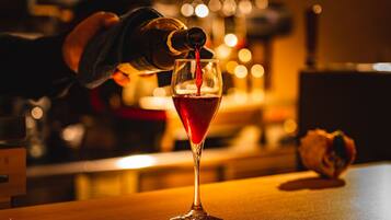 A cocktail being poured into a glass.