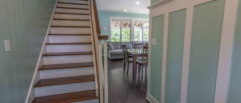 A staircase leading to a dining area with a table and chairs.