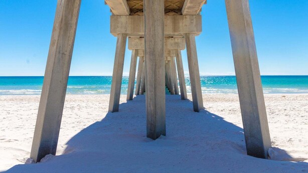 A concrete pier structure with multiple pillars leading to a beach. - "SummerTowne 1-At Pier Park"| Amazing Ocean Views | Dog-Friendly | Community Pool (Panama City Beach)