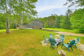A house with a deck and outdoor seating area. - Lakefront Escape w/ Deck & Kayaks in Lovell! (Lovell)