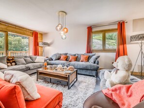 A cozy living room with a sofa set, a coffee table with breakfast items, and a teddy bear. - Luxury 5-room in Tignes, 8-10 people, hotel service (Tignes)