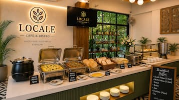 A cafe counter with labeled food options and a sign indicating breakfast buffet availability.