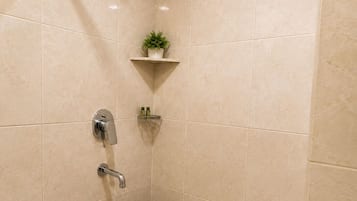 A bathroom with a shower, a toilet, and a sink.