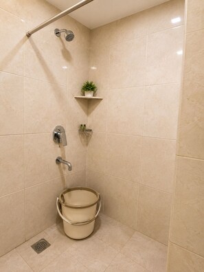 A bathroom with a shower, a toilet, and a sink. - Room-la Riviera Suites Premium Stay in (Hyderabad)