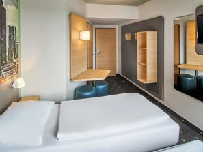 A modern hotel room with a bed, a desk, and a mirror. - B&B Hotel Frankfurt-West (Frankfurt)
