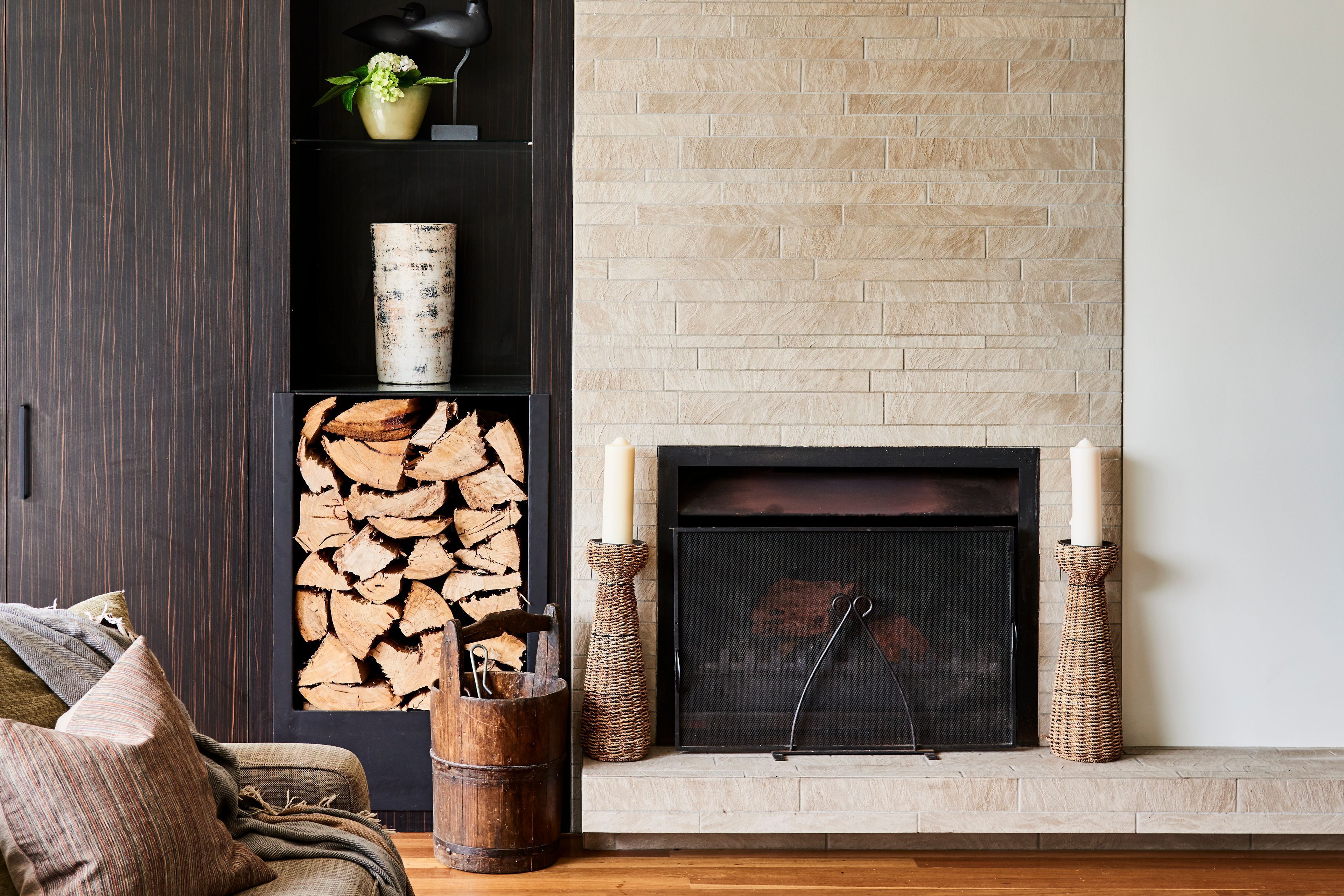 A living room with a fireplace, a bookshelf, and a cozy seating area.