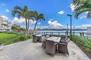 Outdoor dining - By The Sea Shore Stunning Unit Pool Spa Views (Cannonvale)