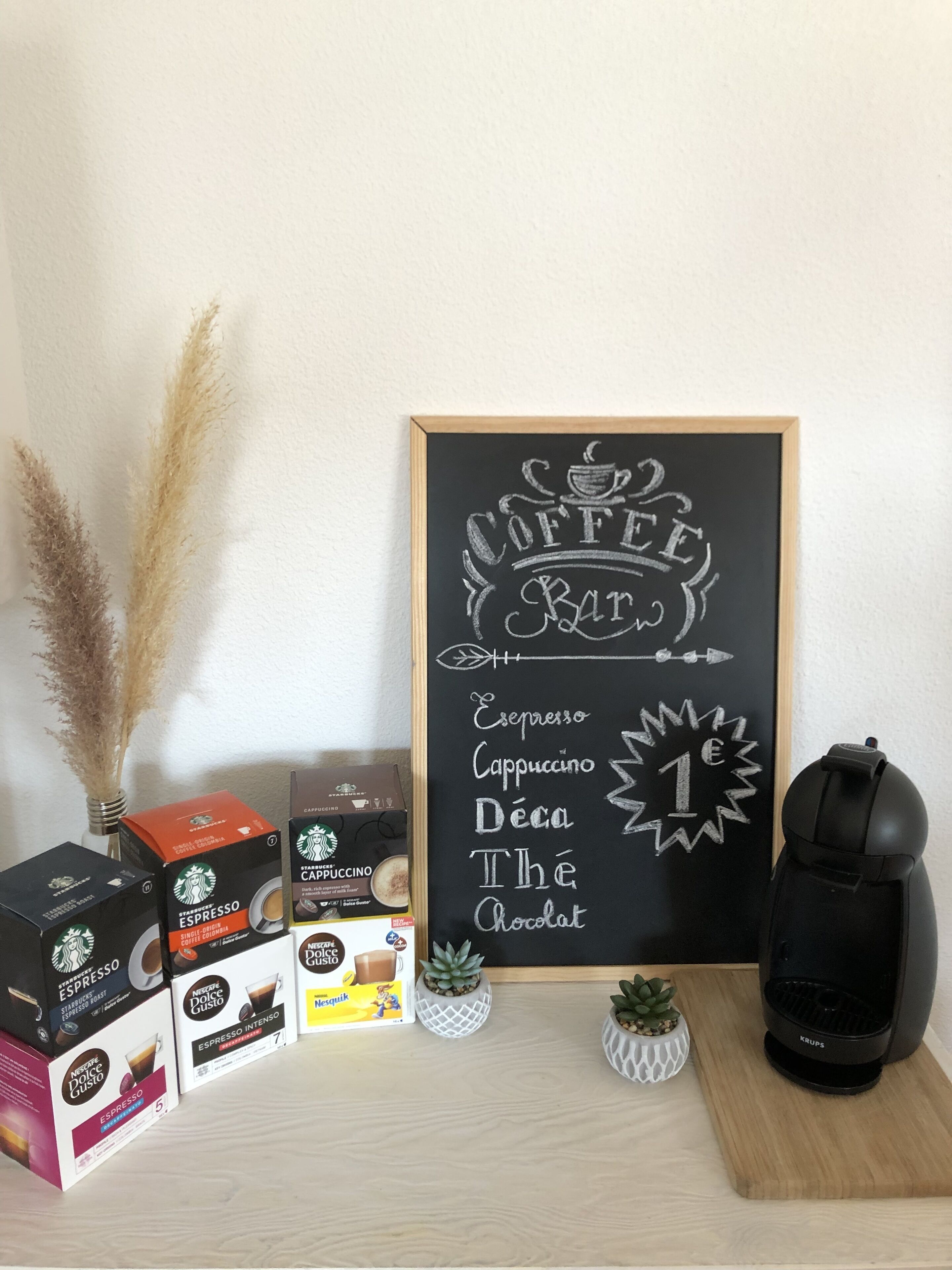 A coffee-themed display with various coffee products and a chalkboard sign listing coffee types.