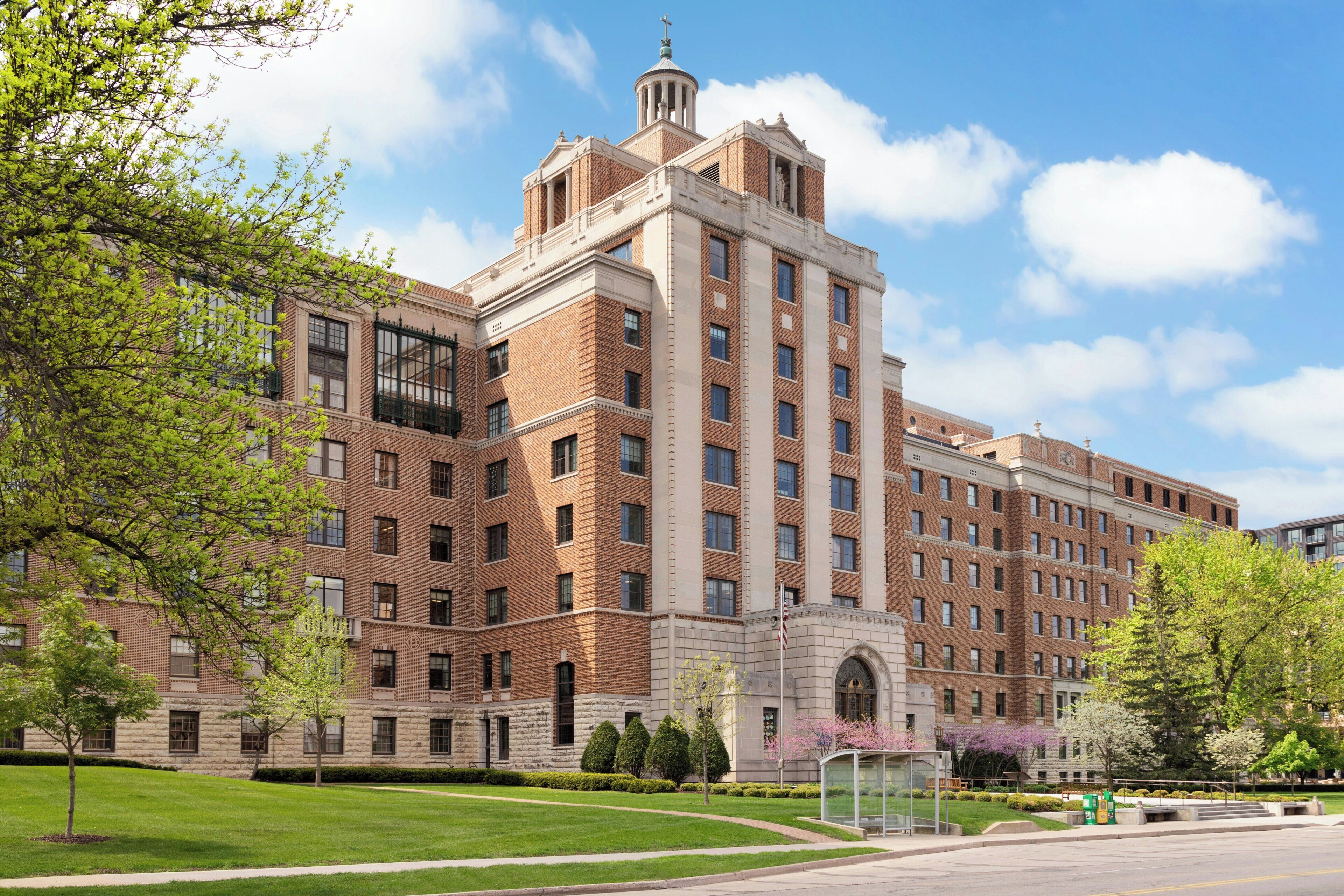 A large brick building with multiple windows and a central entrance.