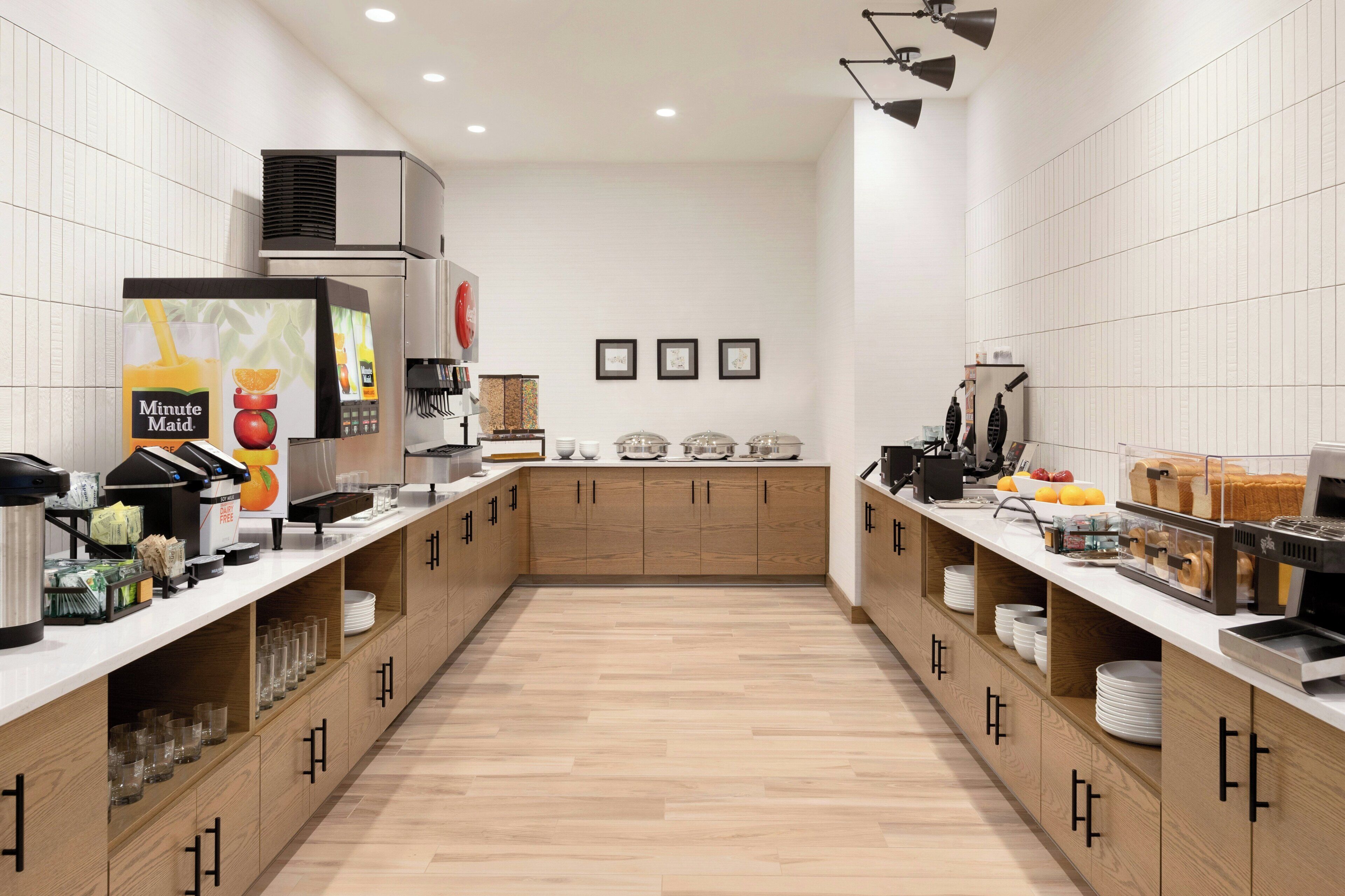 A modern kitchen with a central island, equipped with various appliances and storage cabinets.