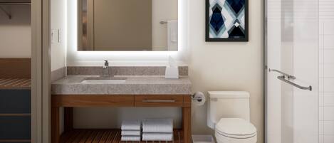 A modern bathroom with a large mirror, a sink, a toilet, and a shower.