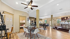 A spacious living room with a dining area, a kitchen, and a stage. - The Ray - Penthouse Suite - Rooftop View (St. Augustine)