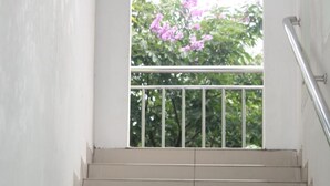 A staircase leading to a balcony with a metal railing. - New Green Sentul Resort (Sentul City)