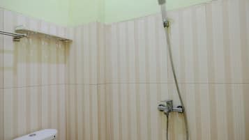 A bathroom with a shower, toilet, and a towel rack.