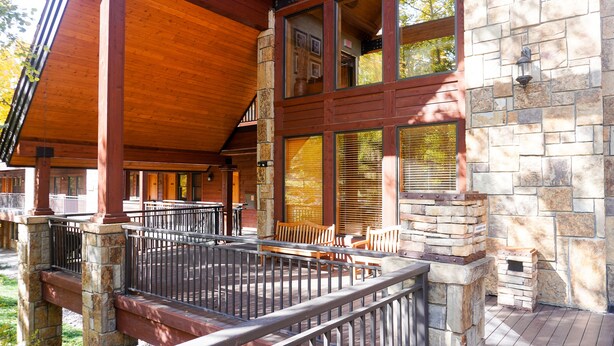 A covered outdoor area with stone walls, wooden benches, and a grill. - Telluride - 1 Bedroom with Forest View (Telluride)