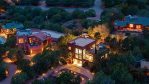 An aerial view of a residential area with multiple houses, each featuring distinct architectural styles and surrounded by lush greenery. - FEATURED in FORBES, 20ft ceilings, AMAZING views, + loft, hot tub, fire pit, EV. (Sedona)