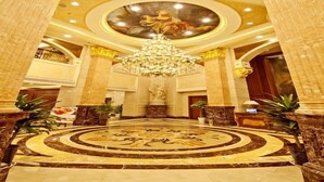 A grand lobby with a large chandelier, marble flooring, and classical artwork on the ceiling. - City Vogue Hotel (Nantong)