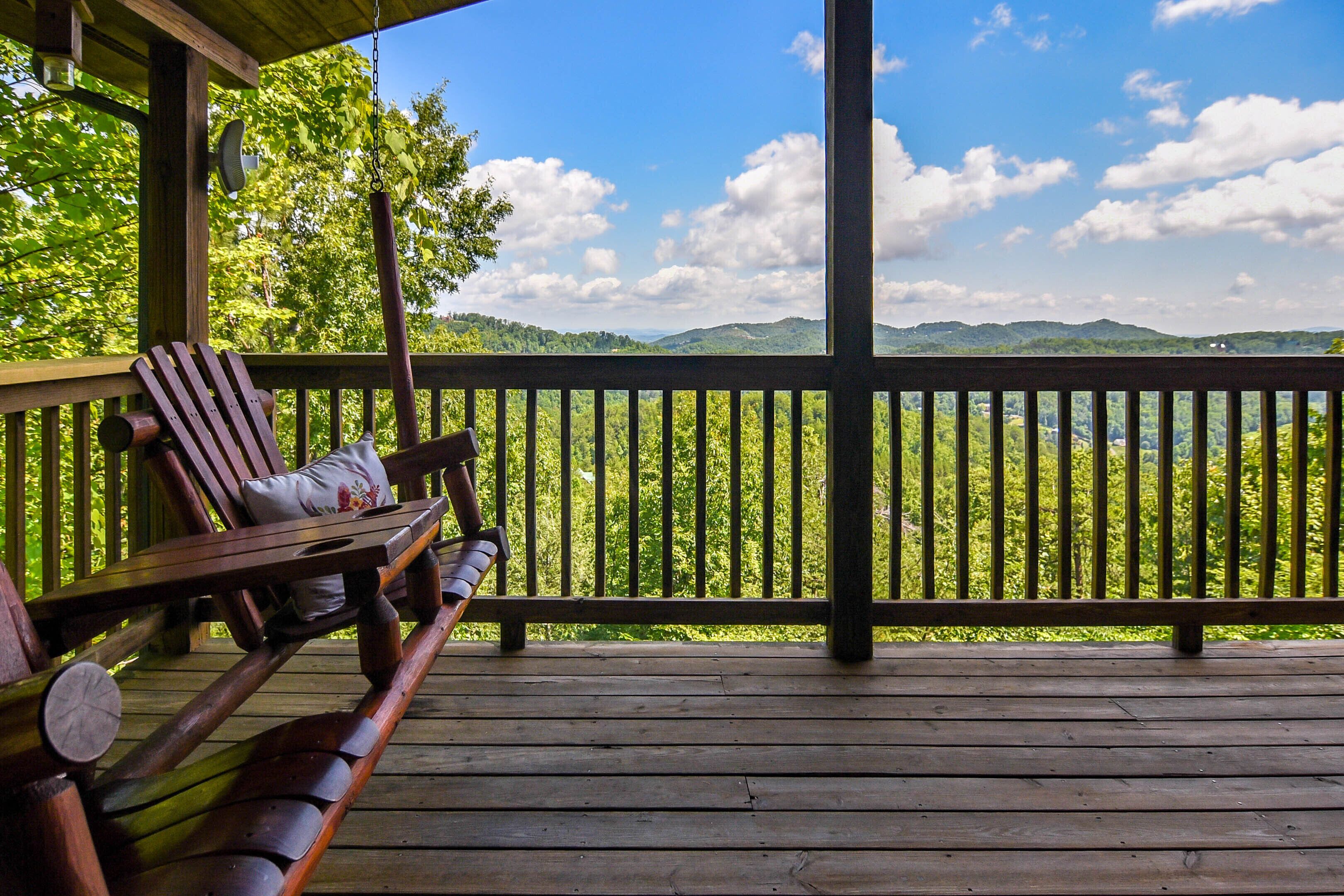A wooden deck with a bench and a hanging light fixture.