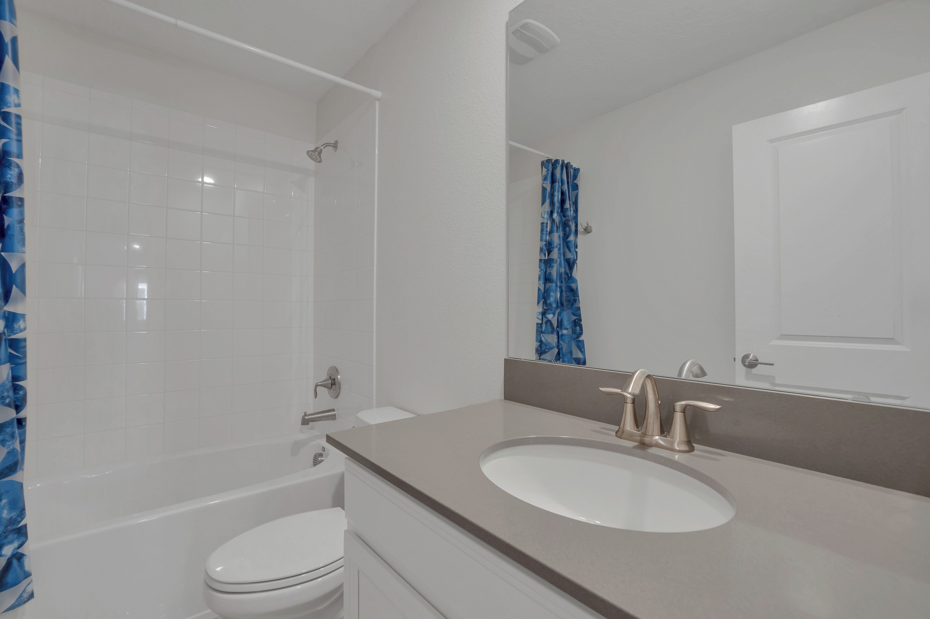A bathroom with a bathtub, toilet, and sink.