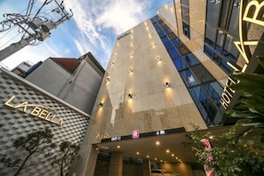 A hotel entrance with a modern design, featuring a prominent 'HOTEL' sign, a parking sign, and a 'LA BELLA' sign. - Daegu Dongseongro Hotel Labella (Daegu)