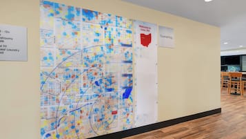 A map of Lima, OH, with a Welcome to Lima sign and a TourneMap sign on the wall.