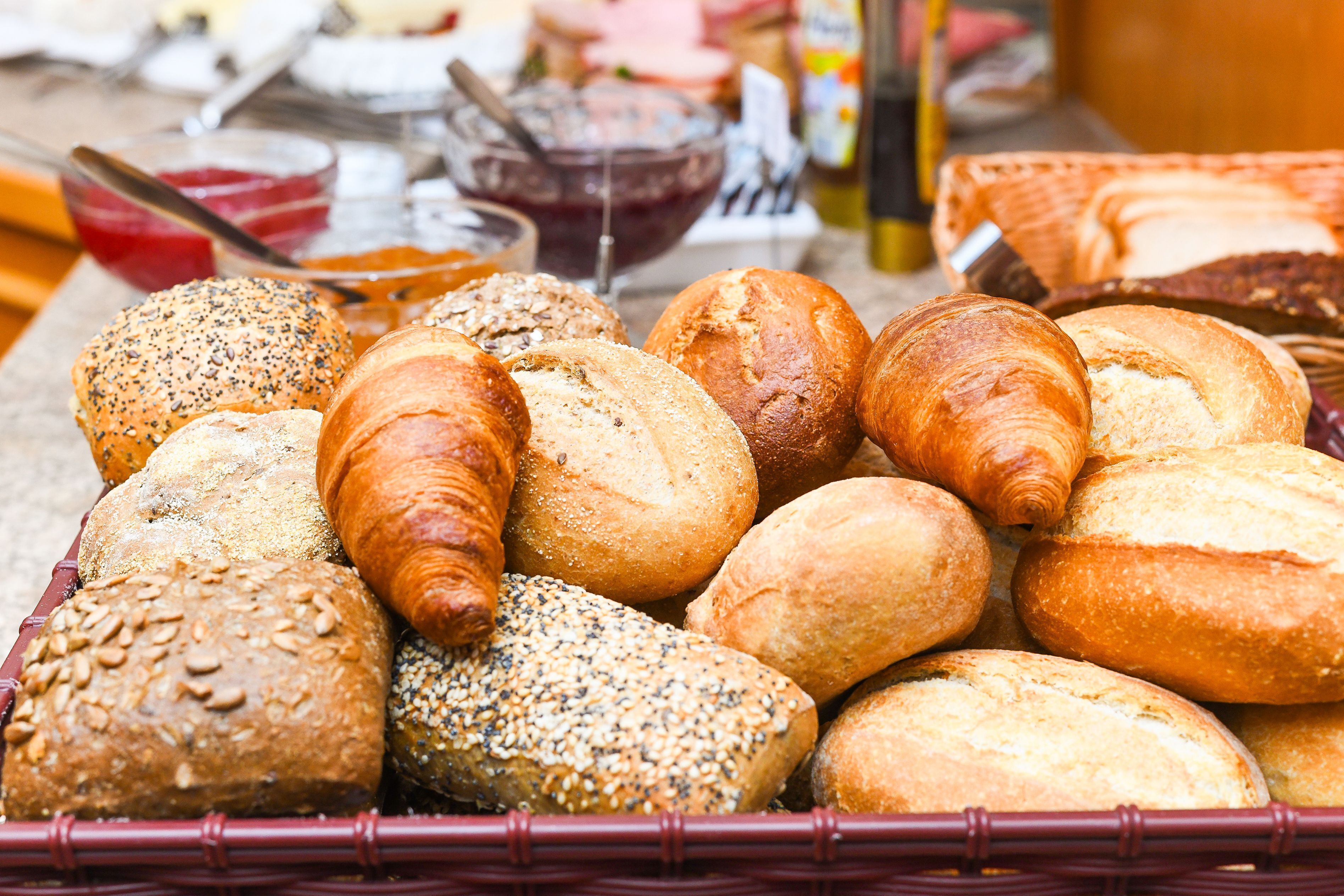 A variety of breads and pastries in a basket.