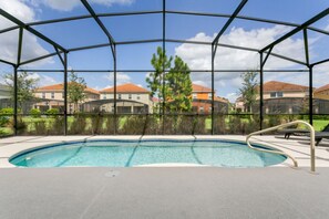 A covered outdoor swimming pool with a view of residential buildings in the background. - Picture Renting Your Own Luxury Villa on the Exclusive Solterra Resort, Close to Disney, Orlando Villa 3681 (Davenport)