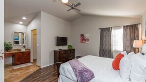 A bedroom with a bed, a dresser, a television, and a ceiling fan. - Backyard Playground! Golf Sport Court & Hot Tub! (Glendale)