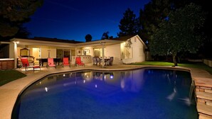 A swimming pool with a covered patio area, outdoor seating, and a house in the background. - Just Listed! Kierland Home w Htd Pool and Hot tub (Scottsdale)