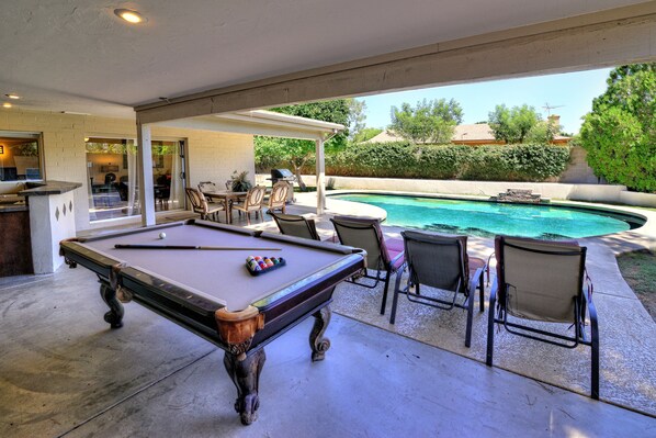 A pool table with chairs and a bar area, a pool, and a covered patio. - Just Listed! Kierland Home w Htd Pool and Hot tub (Scottsdale)