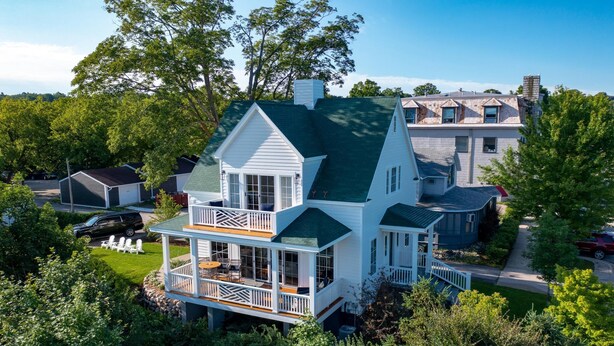 A two-story house with a wrap-around porch and a large front deck. - New Downtown Petoskey Custom Home.  (Petoskey)