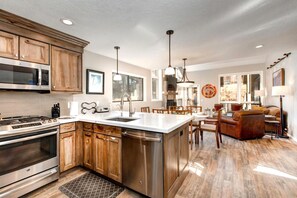 A spacious kitchen with wooden cabinets, stainless steel appliances, and a large island.