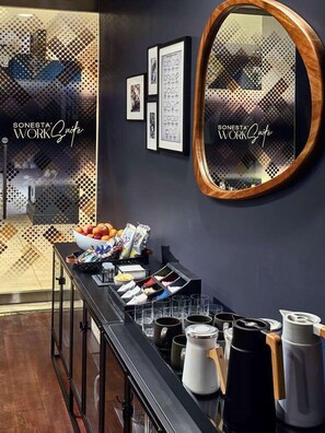 A bar area with a black counter, various food items, and a large mirror. - Sonesta Charlotte (Charlotte)