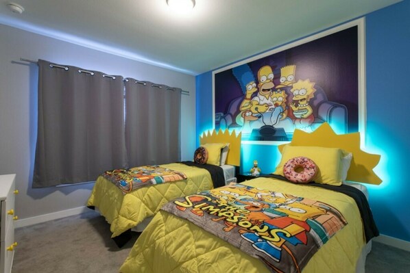 A bedroom with two beds, each with a Simpsons-themed bedspread. There is a large Simpsons mural on the wall. - Le Reve 4 Bedroom Vacation Home 4451 (Kissimmee)