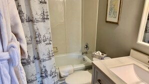A bathroom with a bathtub, toilet, and sink. - 202 - Executive Rm Lake View- Balcony 2 DBL (Port Elgin)