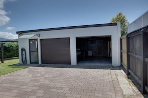 A modern building with a garage, a covered driveway, and a visible outdoor area.