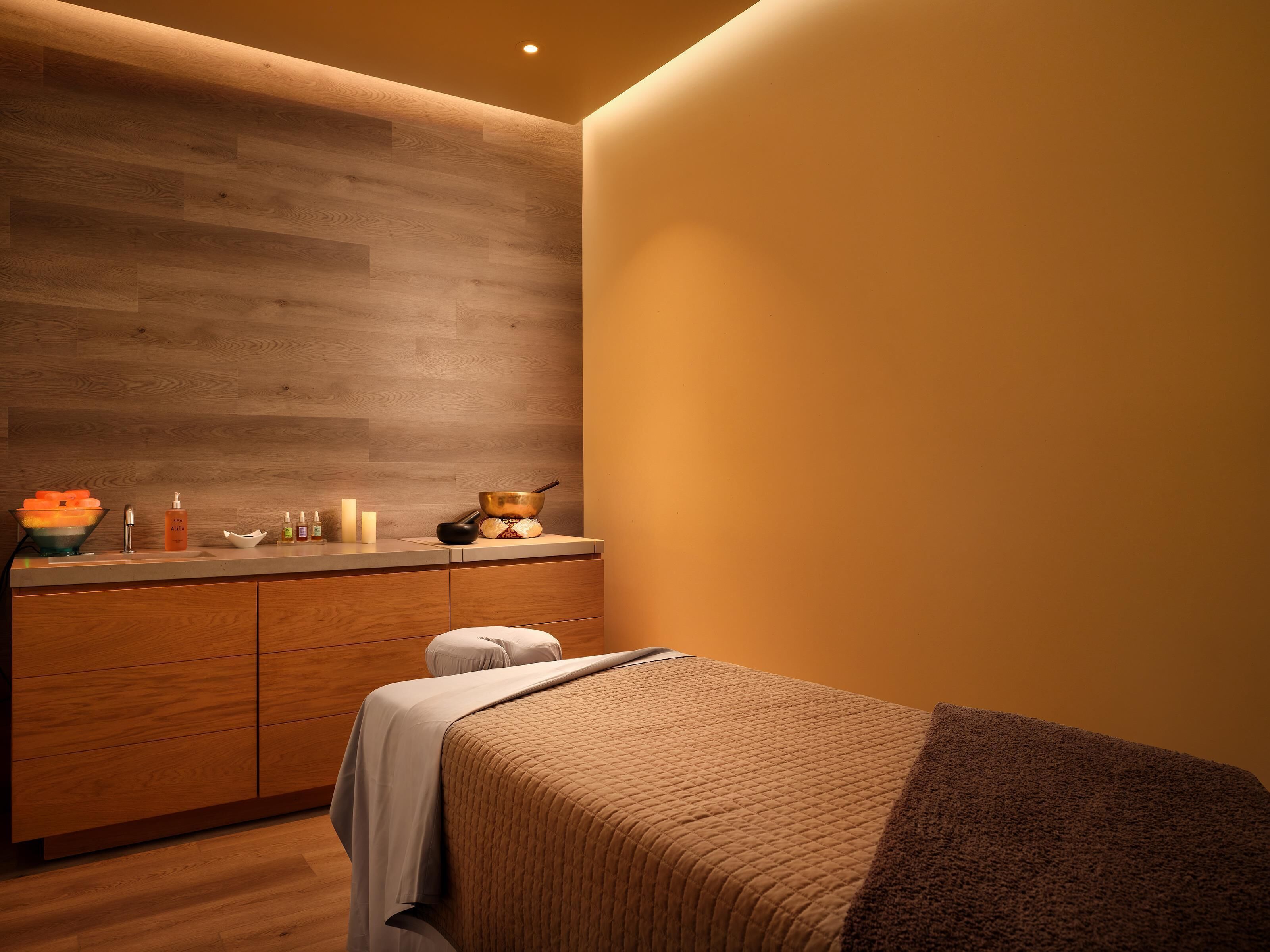 A modern bathroom with a wooden vanity, a towel, and a bowl.