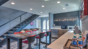A modern kitchen with a central island, bar stools, and a staircase. - Cellar 74: New Modern Wine Casita w/Hot tub (Albuquerque)