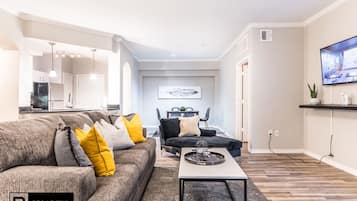 Deluxe Apartment, 2 Bedrooms | Living room | 50-inch Smart TV with digital channels, TV, fireplace