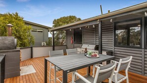 A deck with a table and chairs, a grill, and a chimney. - Silvers Anchor - 2 Bennett Street (CARRICKALINGA)