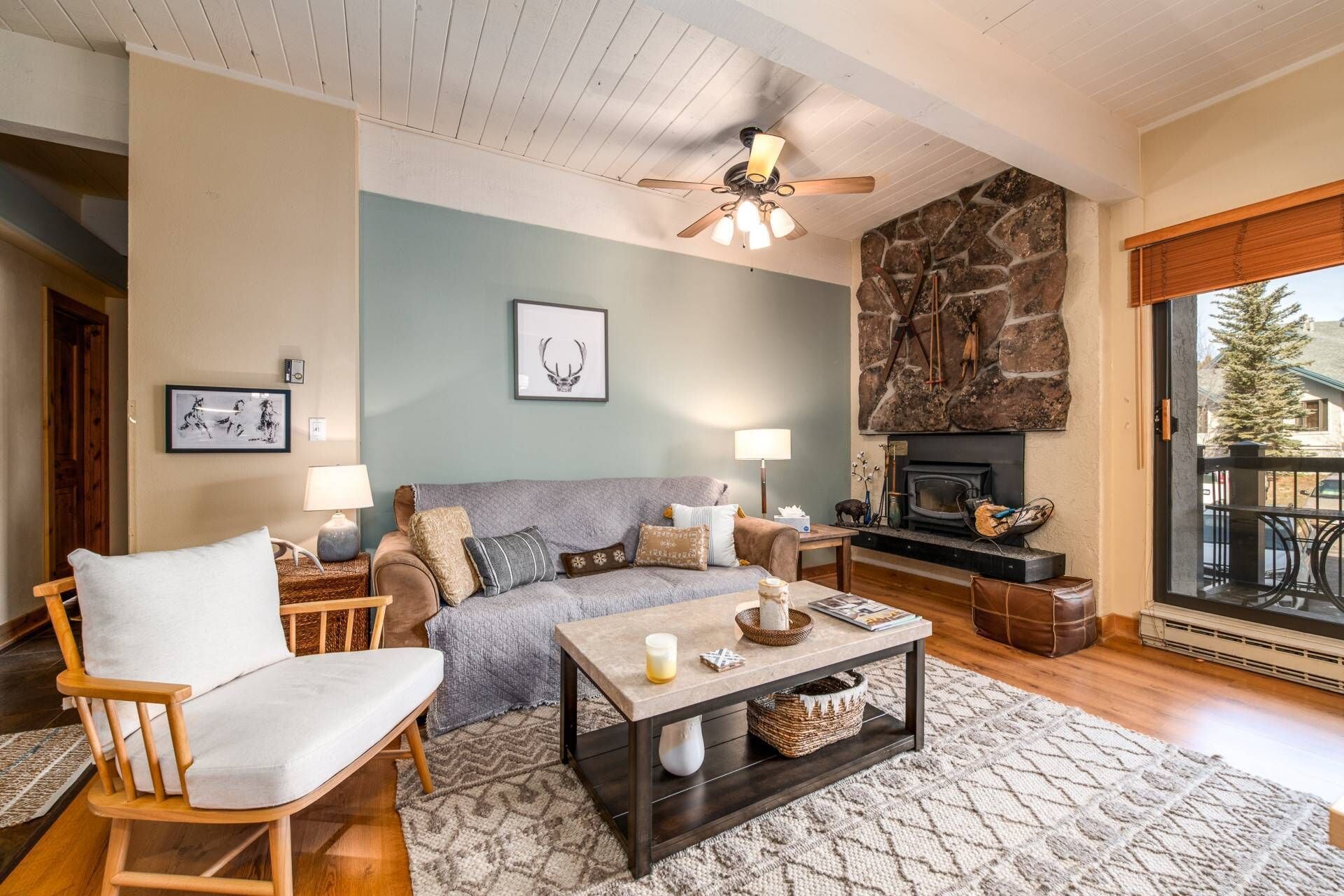 Warm mountain retreat with rustic charm — cozy fireplace, comfy seating, and natural light for the perfect relaxing escape.