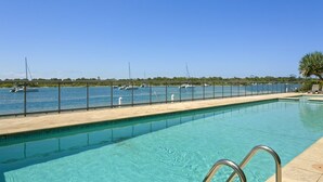 A swimming pool with a clear view of the sea and boats in the background. - Noosa Shores (Noosa Heads)