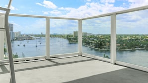 A high-rise room with large windows overlooking a river and cityscape. - Tiffany Ebony: 11th FL,Ocean-Canal views, Walk to Beach (Fort Lauderdale)