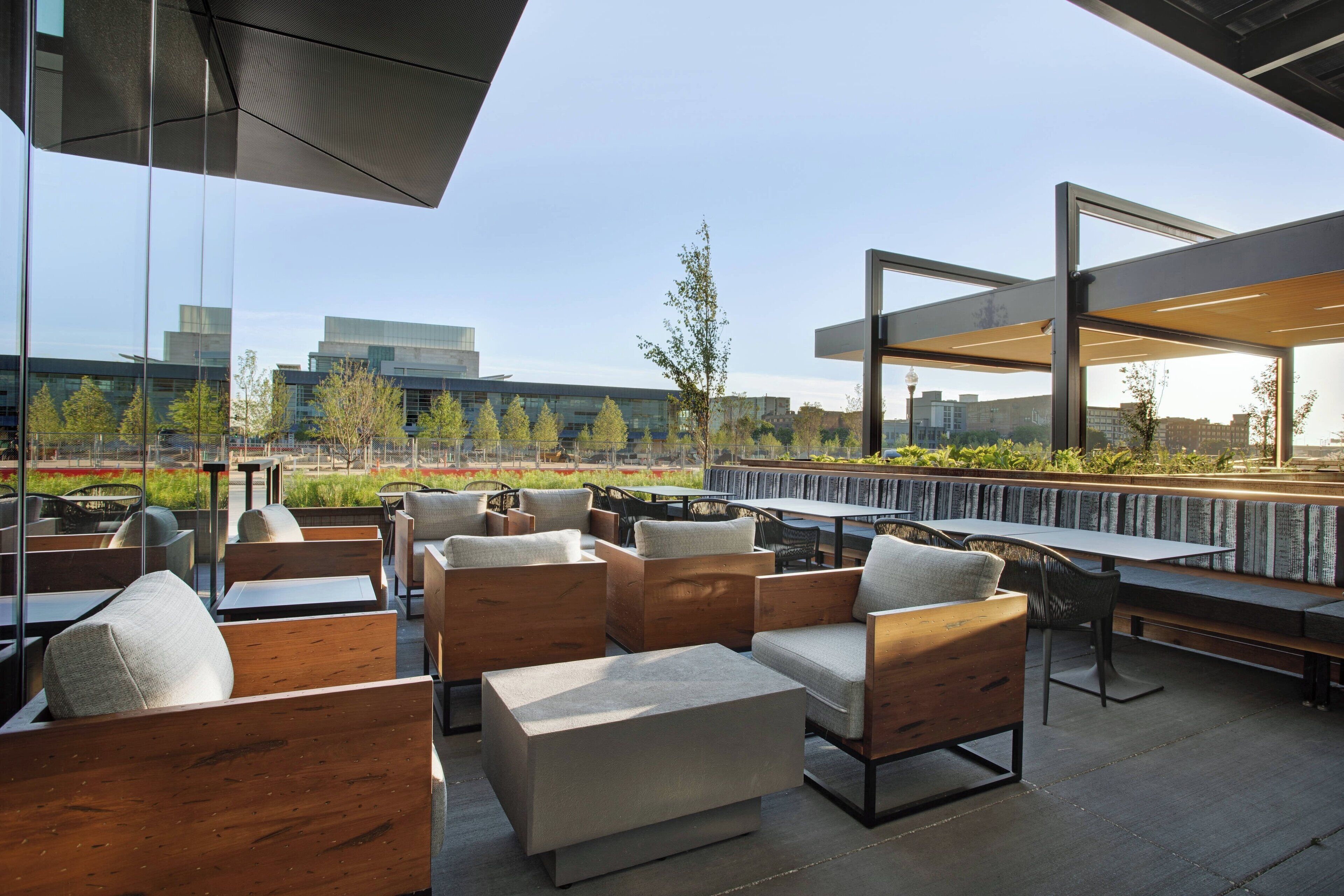 An outdoor seating area with wooden furniture and a view of buildings in the background.