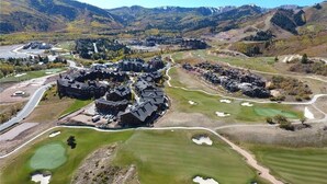 A golf course with bunkers and a clubhouse. - Stunning! Walk to lift - Beautiful pool complex (Park City)
