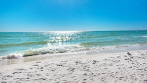 A beach with clear skies and calm waters.