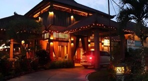 A two-story house with a covered porch, a car parked in front, and a 'Welcome' sign. - Nyiur Resort Hotel (Pangandaran)